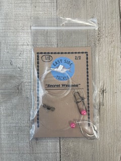 Packaged pompano rig with a label on a wooden surface